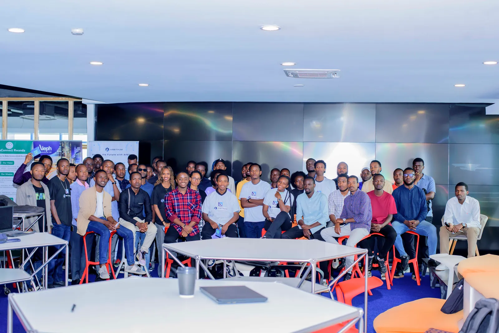 Developers talking through ideas together around tables at a workshop